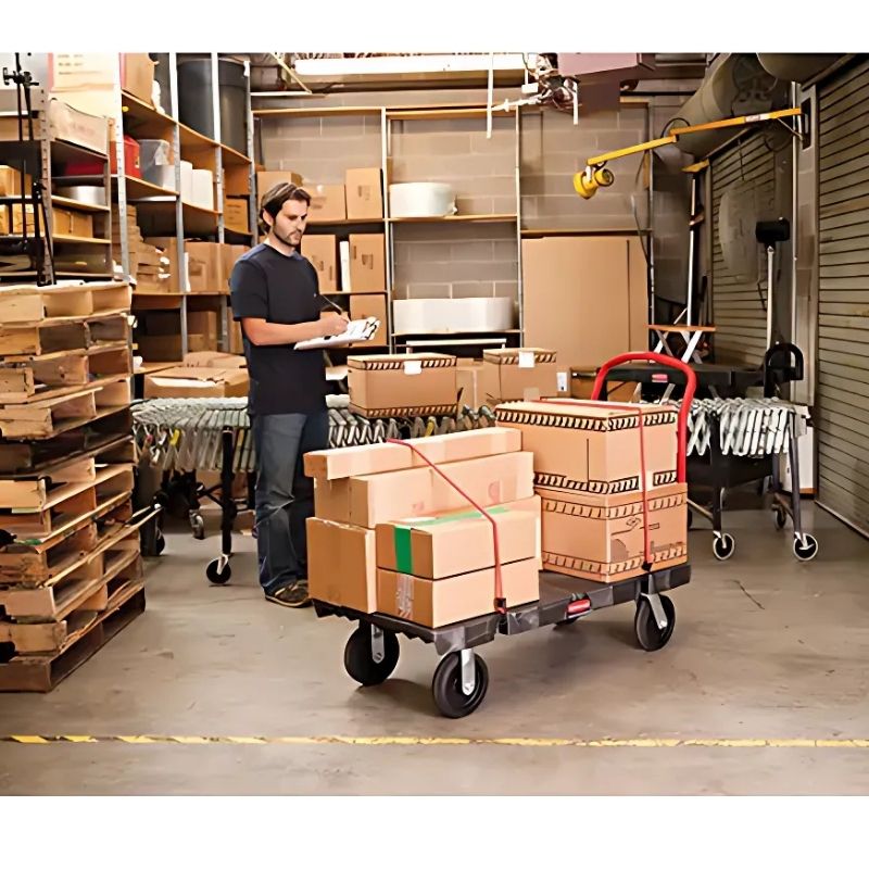 RubbermaidHeavy-DutyPlatformTruck_60Lx30W_2500lbs.Cap._PolyolefinWheels_1- man in storage room with platform truck