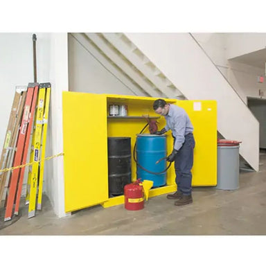 JustriteSure-GripEXVerticalDrumStorageCabinets_110USgal.Cap._2Drums_Yellow_1-man organizing the cabinet