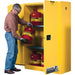 JustriteSure-GripExFlammableStorageCabinets_45gal._2Door_43Wx65Hx18D_2- a man holding a tank infront of Flammable Storage Cabinets
