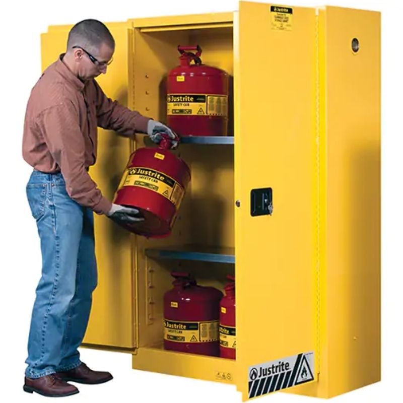 JustriteSure-GripExFlammableStorageCabinets_45gal._2Door_43Wx65Hx18D_2- a man holding a tank infront of Flammable Storage Cabinets